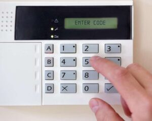 00114-person-entering-a-code-to-activate-the-burglar-alarm-and-protect-their-home-16-9